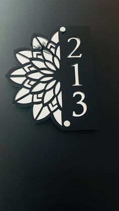 a black table with a white clock and some flowers on it's back side