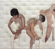 two naked people laying on top of a bed with wires attached to their butts