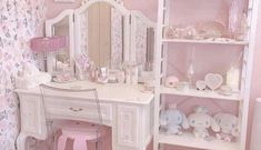 there is a white vanity with pink flowers on the walls and shelving in the room