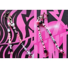 two pink and black beaded necklaces are on a zebra print background with the word love