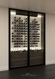 the wine cellar is full of many different types of bottles and glasses in glass doors