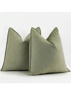 two green pillows sitting on top of each other