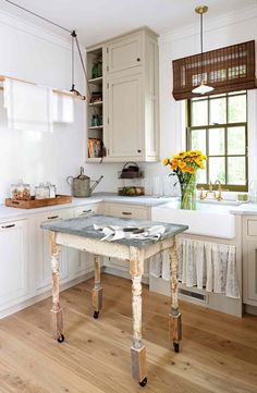 the kitchen is clean and ready to be used for cooking or baking, as well as flowers on the table