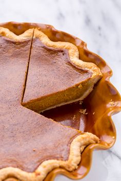 a piece of pie sitting on top of a pan covered in caramel glaze