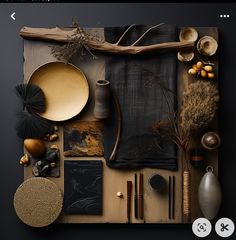 an assortment of decorative items displayed on a black tablecloth with gold accents and wooden sticks