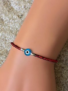 These evil eye bracelets are handmade-to-order just for you! 🧿 Evil eye jewelry dates as far back as 3000 BC. Many ancient cultures wore amulets or jewelry with the evil eye symbol to protect them. Today the evil eye brings good luck and good vibes. An evil eye in light blue also represents inner peace, solitude and overall protection! Each one is made-to-order and features a handmade lampwork evil eye bead surrounded by Hematite beads. Hematite is known for it's grounding properties. Because e Red Evil Eye Bracelet, Beaded Evil Eye, Red Evil Eye, Eye Bracelets, Greek Evil Eye, Eye Symbol, Red String, Bracelet Dainty, Protection Bracelet