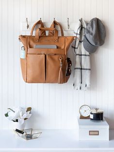 a purse and hat hanging on a wall