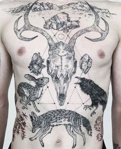 a man's back with tattoos and animals on his body, including an antelope