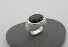 Elegant, simple silver ring with transversely aligned onyx in oval cabochon cut and beautiful dark black. Onyx oval 12 x 16mm All ring sizes are available. Please write your ring size in the comment field by checking out. On the following link, you will find the ring with a larger stone 20 x 15mm https://www.etsy.com/de/listing/228065410/grosser-onix-ring-in-silber-925?ref=shop_home_active_17 Modern Onyx Signet Ring With Polished Finish, Modern Oval Cabochon Signet Ring As Gift, Modern Oval Cabochon Signet Ring For Formal Occasions, Modern Oval Cabochon Signet Ring For Gift, Modern Oval Cabochon Dome Ring, Modern Domed Signet Ring, Minimalist Oval Cabochon Signet Ring For Formal, Minimalist Oval Cabochon Signet Ring For Formal Occasions, Modern Domed Cabochon Rings