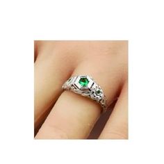 This exquisite vintage ring features a stunning simulated emerald set in anti-tarnish rhodium plated 925 solid sterling silver. The intricate filigree design adds a touch of elegance to the piece, complemented by the simulated emerald accent stones. You can find the 925 stamp on the ring, indicating its high quality and authenticity. Vintage White Gold May Birthstone Rings, Vintage Hallmarked May Birthstone Ring, Antique Silver Emerald Ring As Gift, Antique Silver Emerald Ring For Gift, Antique Style Silver Emerald Ring For Gift, Antique Sterling Silver Emerald Ring Gift, Silver Emerald Birthstone Ring For Anniversary, Vintage Gemstone Ring For May Birthstone, Vintage Hallmarked Emerald Ring In Sterling Silver