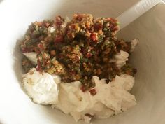 a white bowl filled with food on top of a table