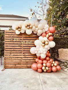 a large balloon arch with gold and white balloons