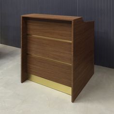 an empty wooden desk in front of a blue wall with gold trimming on it