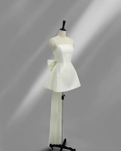 a mannequin with a white dress on a stand