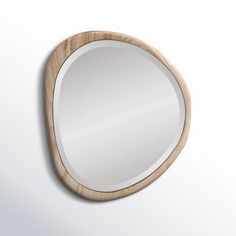 a wooden mirror hanging on the wall