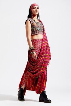 Red pre-draped saree, with multi color printed motifs, highlighted with sequins  spread and cowry shells and tassel embellishments.
Component: 1
Embellished
Fabric: Cotton Silk, Georgette
Color: Red, Multi Color
Cowry shells and tassels on palla hem
Note: The blouse and the bandana worn by the model is for styling purpose only - Aza Fashions Festive Bohemian Pre-draped Saree, Bohemian Pre-draped Saree For Eid, Bohemian Pre-draped Saree For Festivals, Traditional Draped Lehenga With Mirror Work, Multicolor Embellished Pre-draped Saree For Festive Occasions, Bohemian Pre-draped Saree For Navratri, Embellished Multicolor Pre-draped Saree For Festive Occasions, Festive Multicolor Embellished Pre-draped Saree, Draped Lehenga With Mirror Work For Festivals