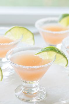 three margaritas with lime and sugar garnish in small glasses