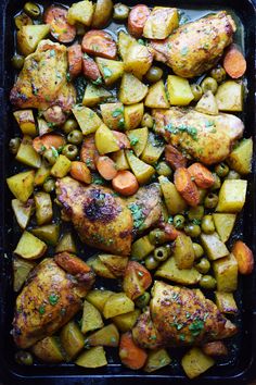 chicken, potatoes and olives on a baking sheet