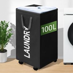 a laundry hamper next to a washing machine and a potted plant on a table