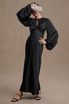 A slim midi silhouette boasts full-length balloon sleeves and twisted-front detailing to create an enchanting statement. An alluring open back and center front cutout set the Significant Other Demi Long-Sleeve Column Gown apart. | Demi Backless Long-Sleeve Column Gown by Significant Other in Black, Women's, Size: 4, Polyester/Rayon/Elastane at Anthropologie Long Sleeve Bridesmaid Dress, Black Bridesmaids, Guest Attire, Wedding Attire Guest, Black Bridesmaid Dresses, Column Gown, Little White Dresses, Significant Other, Tie Dress