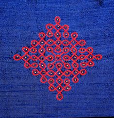 a blue background with red and black designs on the bottom right corner is an intricate design