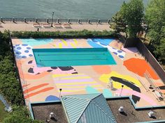 an aerial view of a swimming pool with colorful paint on it