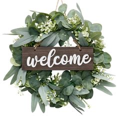 PRICES MAY VARY. ◎Well Decoration：Handmade eucalyptus Wreath, White flowers and green eucalyptus, vivid natural form, giving people artistic romantic feelings, The "Welcome" on the wreath is a greeting to you, and also a perfect welcome sign for neighbors, relatives and friends.The package includes a eucalyptus wreath,a welcome sign board and a sticky hook. ◎Unique Design and Handcraft：The beautiful eucalyptus leaf wreath is made of cloth. Make this wreath fuller and vibrant. Looks realistic and Eucalyptus Wreaths, Summer Door Decorations, Feuille Eucalyptus, Wooden Welcome Signs, Green Eucalyptus, House Front Door, Eucalyptus Wreath, Green Wreath, Greenery Wreath