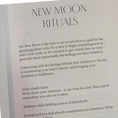 an open book with the text new moon rituals written in black and white on it