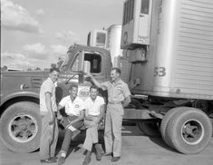 black and white photograph of three men in front of a semi truck