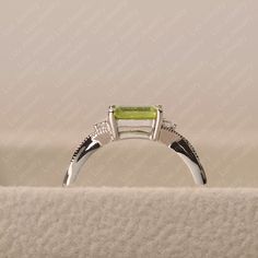 Elegant Peridot Emerald Promise Ring, Emerald Cut Peridot Ring For May Birthstone, Emerald Cut Peridot Ring In Green, Emerald Cut Peridot Green Ring, Green Emerald Cut Peridot Ring, Rectangular Sterling Silver Emerald Ring For Wedding, Rectangular Emerald Ring In Sterling Silver For Wedding, Emerald Cut Peridot Birthstone Ring, Emerald Cut Peridot Ring Gift