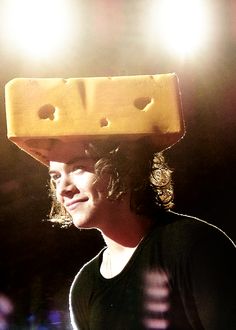 a woman wearing a cheese hat on her head