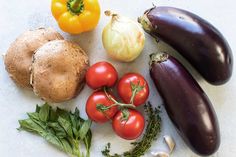 an assortment of vegetables including eggplant, tomatoes and mushrooms