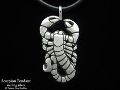 "Hand carved, cast scorpion scorpio pendant / necklace in sterling silver by artist and designer Paxton Mobley (Please Note: This is a larger sized pendant (one of the listing images shows the pendant's size). We also offer a smaller charm size of this design). This original handcrafted scorpion scorpio pendant is sold by itself or with a genuine black leather 3mm cord with sterling silver end caps and lobster clasp. The pendant's bail opening that the cord or chain fits through is approx. 4.7mm Sterling Silver Necklace With Carved Round Pendant, Carved Sterling Silver Pendant Jewelry, Sterling Silver Carved Pendant Jewelry, Carved Pendant Necklace Collectible, Collectible Carved Pendant Necklace, Carved Silver Necklace For Gift, Silver Carved Necklace For Gift, Sterling Silver Amulet Necklace With Carved Details, Carved Sterling Silver Necklace Gift