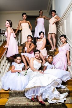 a group of bridesmaids posing on the stairs