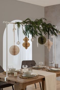 a dining room table is set with plates and cups