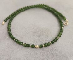 Green jade gemstone beaded chocker,every day necklace Made with smooth 4mm jade beads and 14k solid yellow gold beads and clasp. Please select your prefered length before checkout This minimalist necklace can be worn short as a chocker or longer alone or layered with other necklaces  Measures: 💚4mm  jade smooth beads 💚2mm and 4mm solid gold beads 💚6mm spring ring clasp 100% 14k solid gold hallmarked on clasp Minimalist Jade Jewelry For May Birthstone, Elegant Jade Round Beads Jewelry, Elegant Jade Jewelry With Round Beads, Classic Jade Gemstone Beads Jewelry, Elegant Adjustable Jade Jewelry, Classic Jade Jewelry For May Birthstone, Elegant Jade Beaded Jewelry, Jade Necklaces With Round Beads For Gifts, Jade Necklace With Round Beads For Gifts