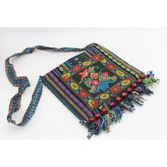 an embroidered bag with tassels and beads on the strap is shown in this image