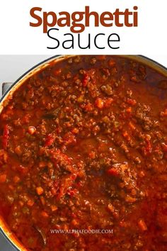 a large pot full of spaghetti sauce on top of a stove with the words spaghetti sauce above it