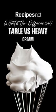 A Close up of a whisk with heavy cream on it with the text what's the difference table vs heavy cream at the top