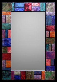 a mirror that is made out of different colored tiles