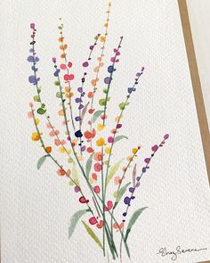 a watercolor painting of some flowers on a white paper with brown trimmings