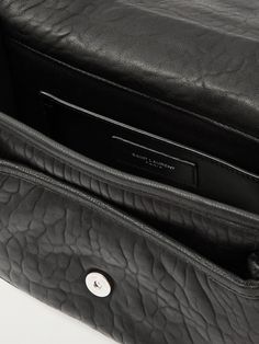 SAINT LAURENT's 'Niki' bag has a muted look that's perfect for everyday use. Appliquéd with a signature 'Cassandre' plaque, it's made from textured-leather and has an adjustable strap so you can wear it crossbody. It has enough space for your wallet, keys and sunglasses, plus an additional slot for notes and receipts. Designer Textured Leather Flap Bag With Top Handle, Designer Textured Leather Top Handle Flap Bag, Designer Textured Leather Crossbody Flap Bag, Luxury Black Flap Bag With Textured Leather, Textured Leather Flap Bags, Evening Shoulder Bag With Leather Lining And Flap Shape, Luxury Black Textured Leather Flap Bag, Designer Leather Flap Bag With Leather Lining, Designer Satchel Flap Bag With Leather Lining