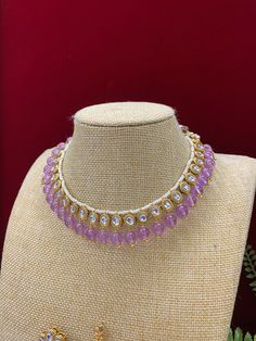 This elegant kundan choker/necklace is gold-plated with kundan work and a pearl neckline. The piece is finished with crystal drops and matching jhumki, all embellished with traditional kundan work. Its length is about 2 inches, with a secure push-back closure. Gold Kundan Necklace With Dori Work, Elegant Gold Kundan Necklace With Dori Work, Kundan Choker Necklace With Stone Work, Elegant Kundan Necklace With Dori Work, Kundan Chandbali Necklace With Mirror Work, Festive Gold Necklace With Dori Work, Festival Kundan Necklace With Dori Work, Gold Kundan Necklace With Dori Work In Bollywood Style, Gold Kundan Necklace With Dori Work In Temple Style