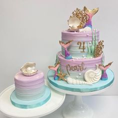 two tiered cake decorated with sea shells and seashells