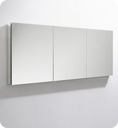 a mirror mounted to the side of a white wall