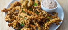 fried food on a plate with dipping sauce