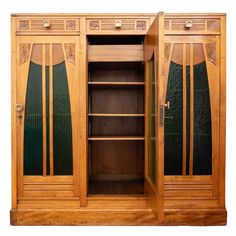 an antique wooden cabinet with glass doors