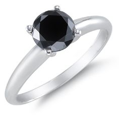 a black diamond engagement ring on a white background with the center stone set in 18k white gold