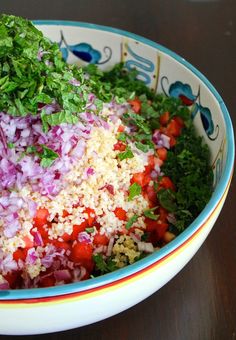 a bowl filled with rice and vegetables on top of a table