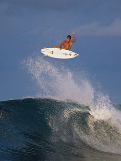 a man riding a wave on top of a surfboard